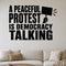 A Peaceful Protest Is Democracy Talking - Democracy Rights Wall Decal removable vinyl wall decal shown on a smooth interior wall
