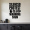Silenced Protest Is a Warning Sign removable vinyl wall decal shown in a styled room.
