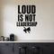 Loud Is Not Leadership removable vinyl wall decal shown in a styled room.