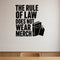 The Rule Of Law Does Not Wear Merch - Political Satire Wall Decal removable vinyl wall decal shown on a smooth interior wall