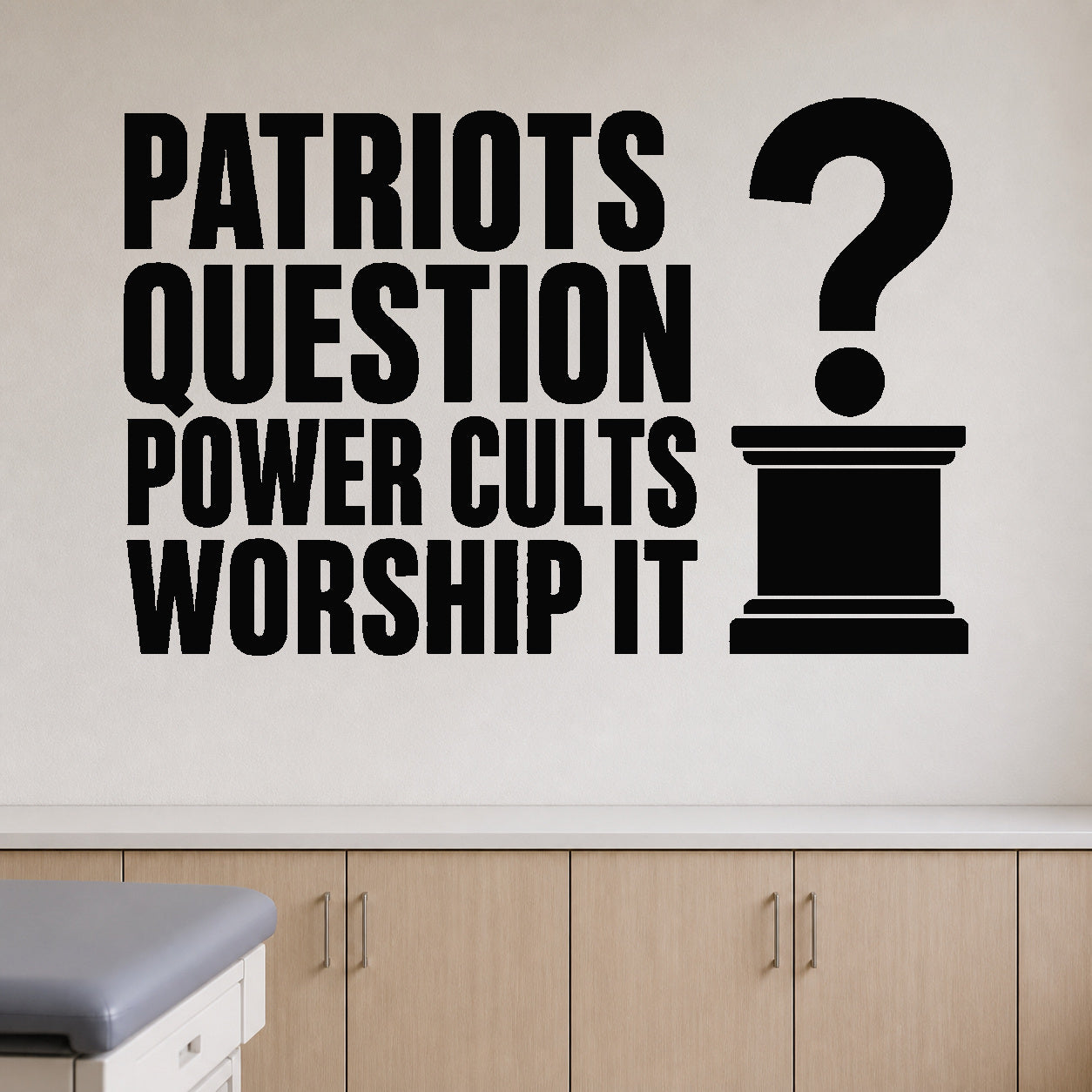 Patriots Question Power Cults Worship It removable vinyl wall decal shown in a styled room.