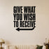 Give What You Wish to Receive removable vinyl wall decal shown in a styled room.