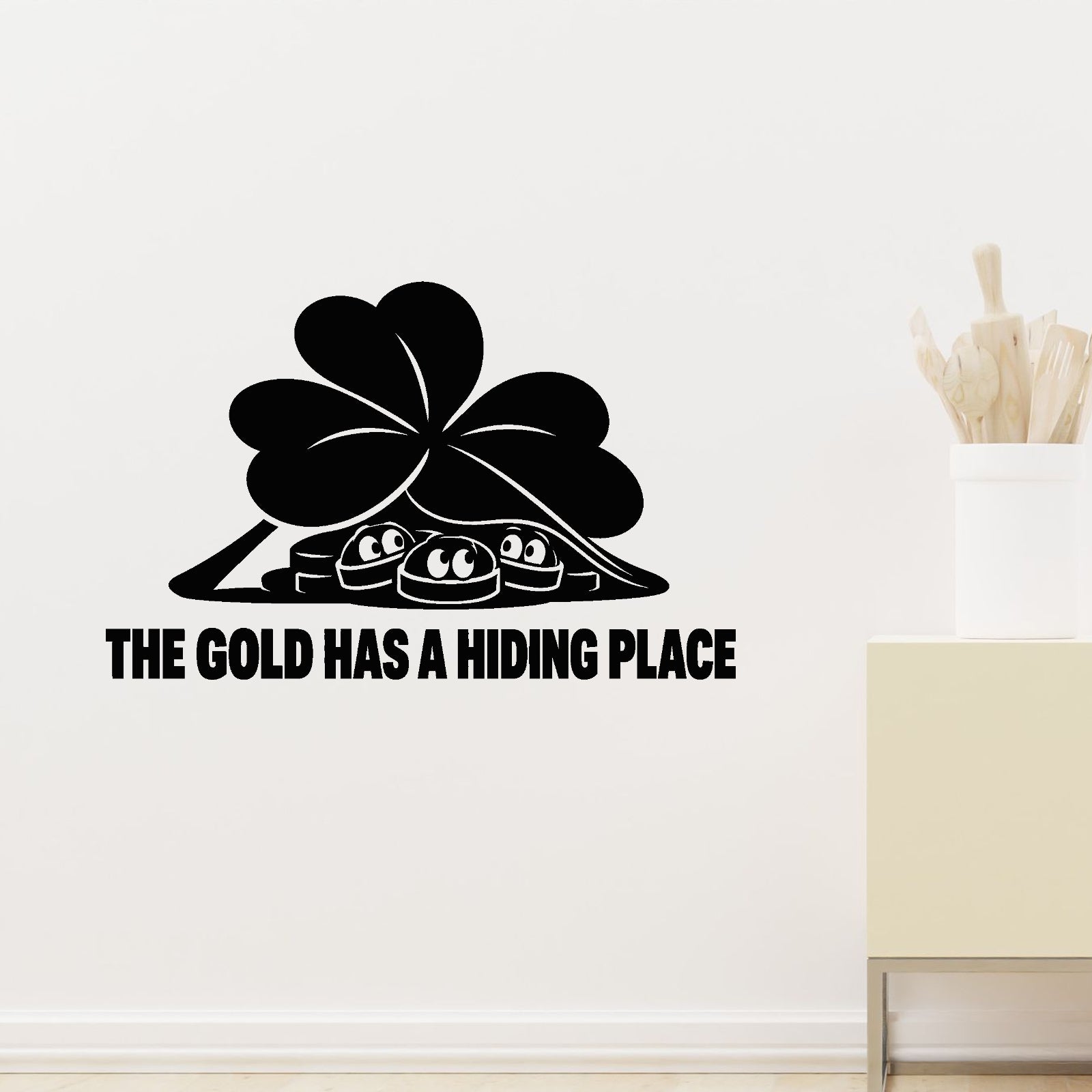 The Gold Has A Hiding Place Removable Wall Decal shown on a clear indoor wall