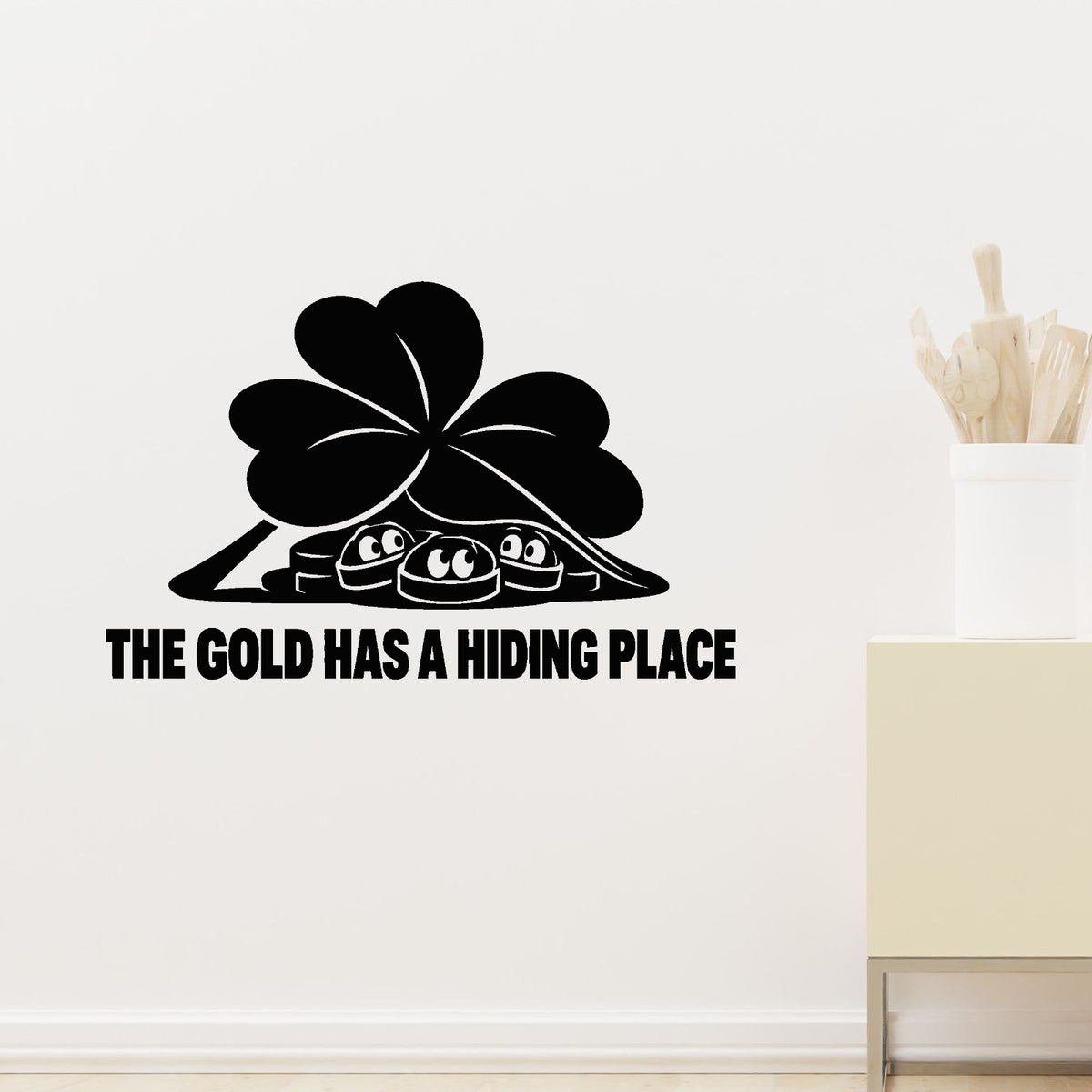 The Gold Has A Hiding Place Removable Wall Decal shown on a clear indoor wall