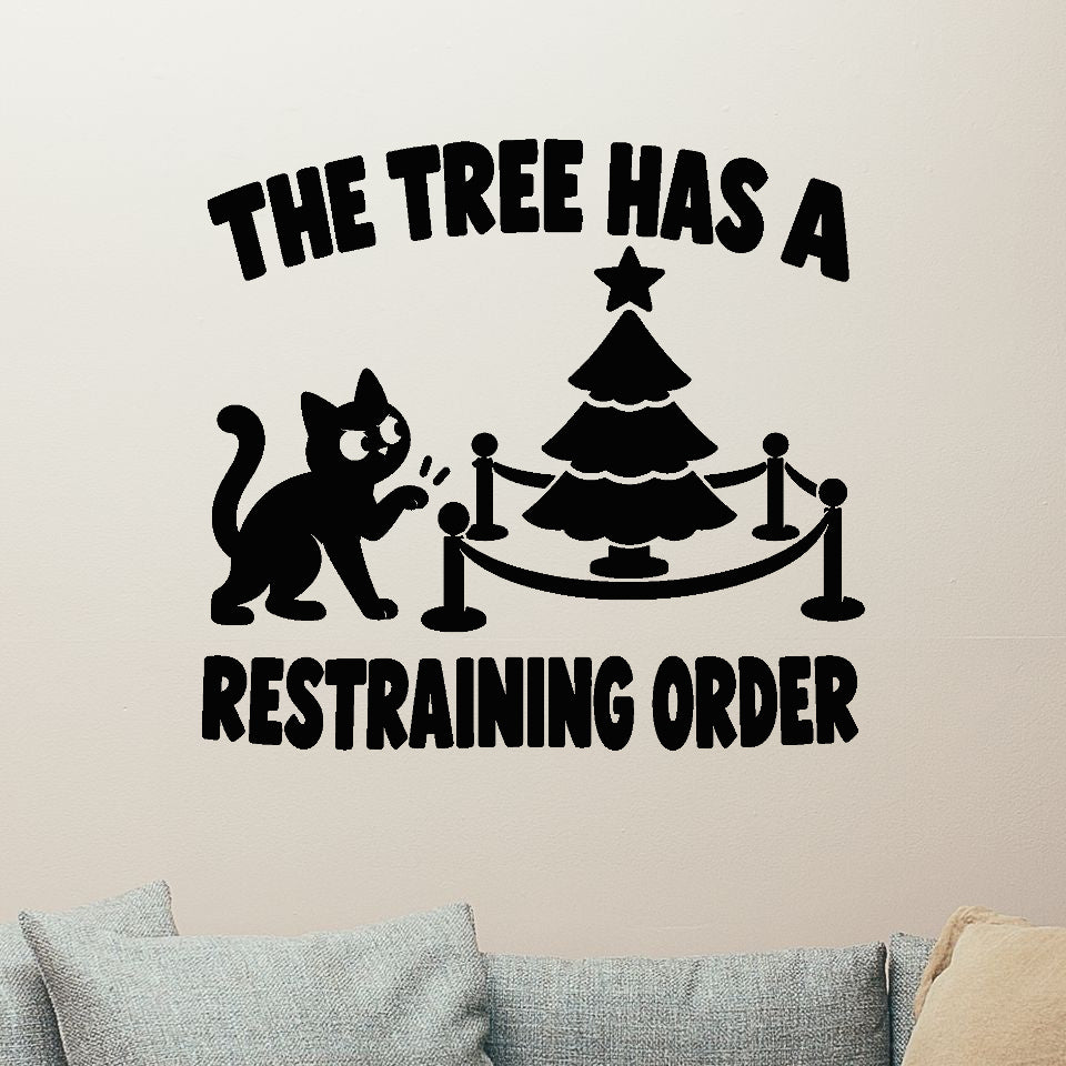 The Tree Has a Restraining Order Christmas cat removable wall decal, black design shown on a clear indoor wall