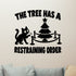 The Tree Has a Restraining Order Christmas cat removable wall decal, black design shown on a clear indoor wall