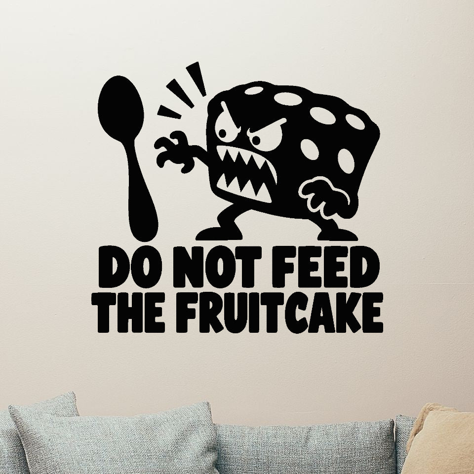Do Not Feed The Fruitcake Removable Wall Decal shown on a clear indoor wall