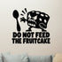 Do Not Feed The Fruitcake Removable Wall Decal shown on a clear indoor wall