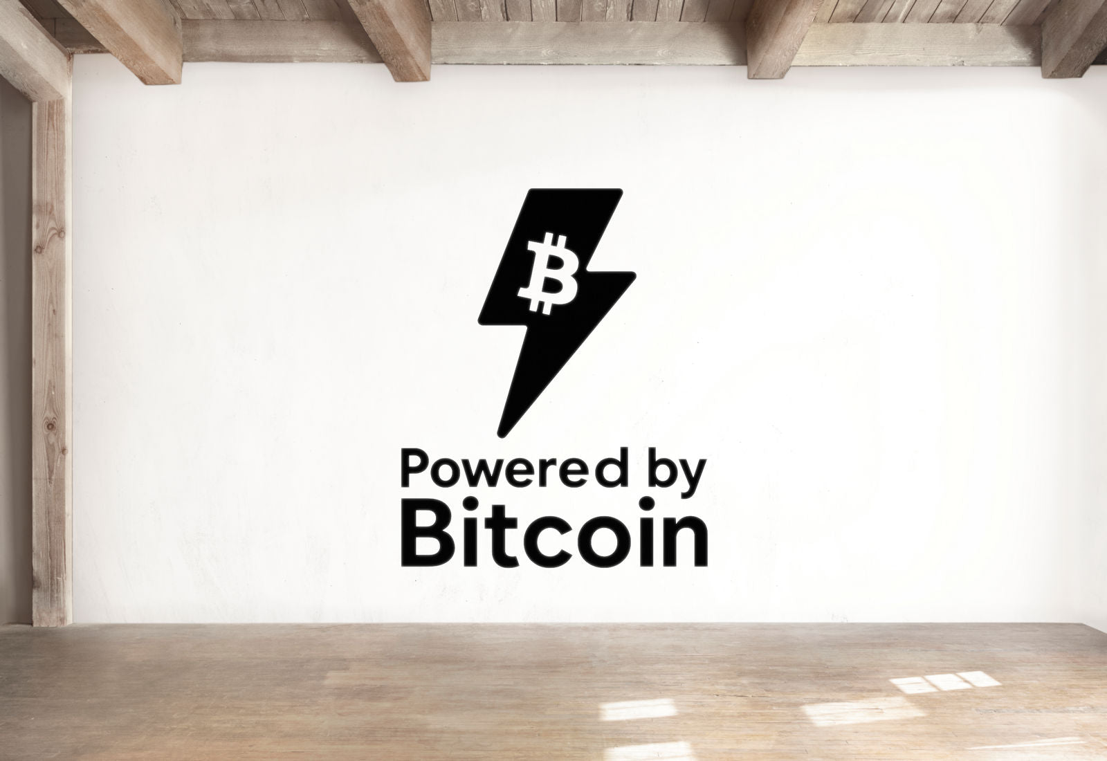 a white wall with a black Bitcoin symbol and text that reads 