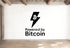 a white wall with a black Bitcoin symbol and text that reads "Powered by Bitcoin".