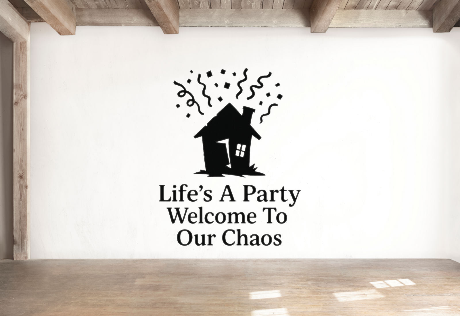 a wall with a black silhouette of a house and confetti, along with the text "Life's A Party Welcome To Our Chaos" written below it.