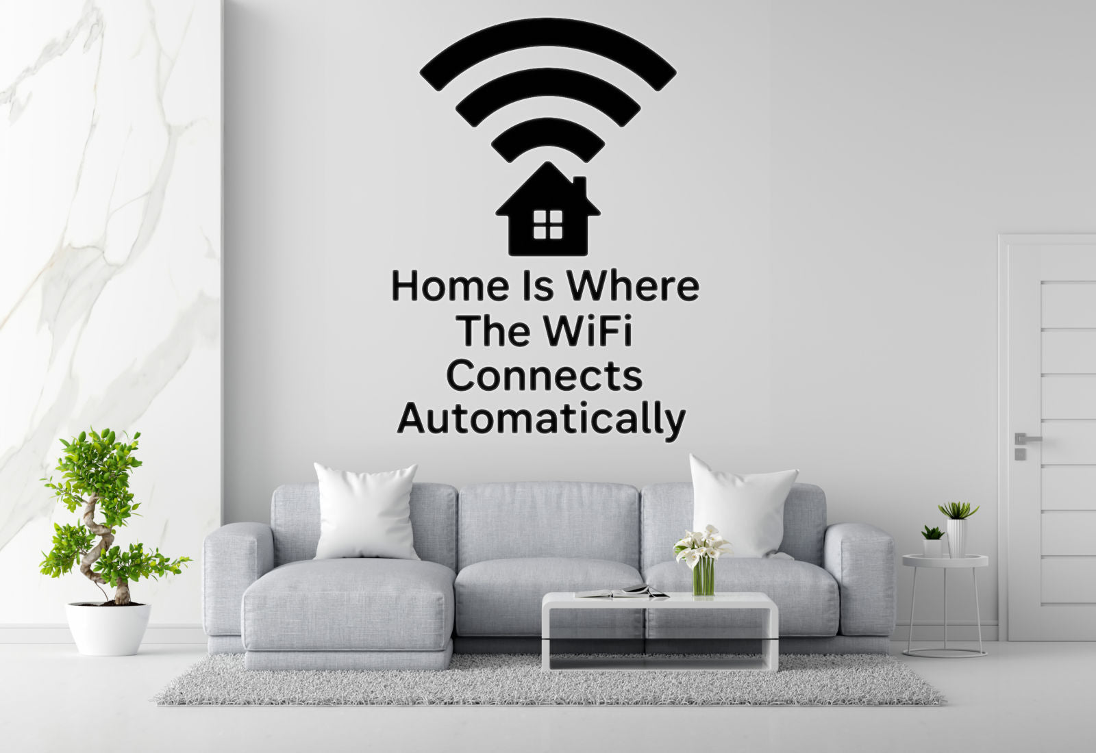 a living room with a gray sofa, a coffee table, and a potted plant. Above the sofa, there is a wall decal that says "Home Is Where The WiFi Connects Automatically".