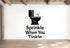 a wall with a black and white graphic of a toilet and the text "Sprinkle When You Tinkle" below it.